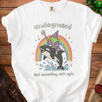 White t-shirt with graphic of green wizard riding orca across rainbow.