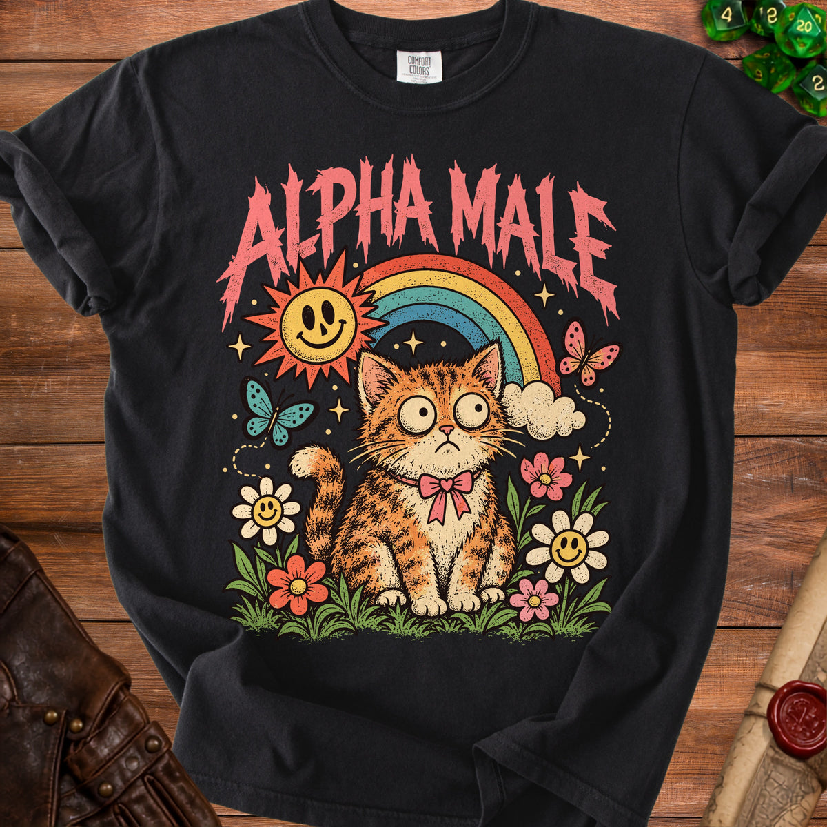 Black t-shirt with "ALPHA MALE" text above a cartoon cat with a rainbow and smiley sun.