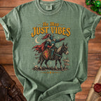 Green t-shirt with knight riding donkey graphic and text "No Map JUST VIBES".