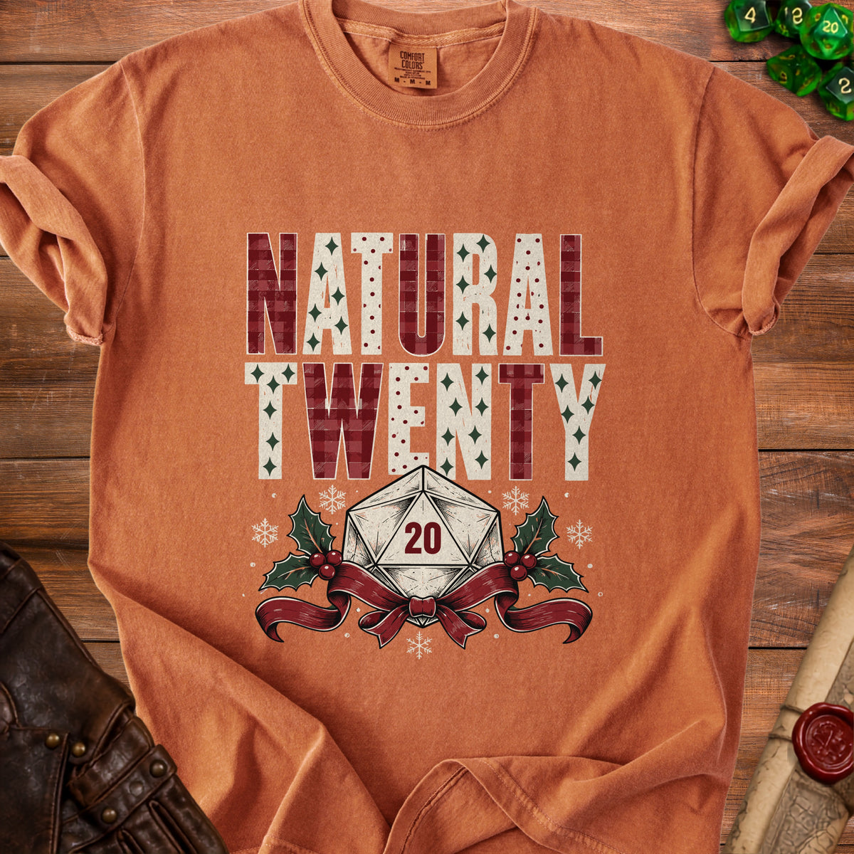 Orange t-shirt with "NATURAL TWENTY" and a d20 dice with holly and ribbon.