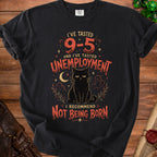 Black t-shirt with a distressed graphic of a cat and the text "I've tasted 9-5 and I've tasted unemployment. I recommend not being born."