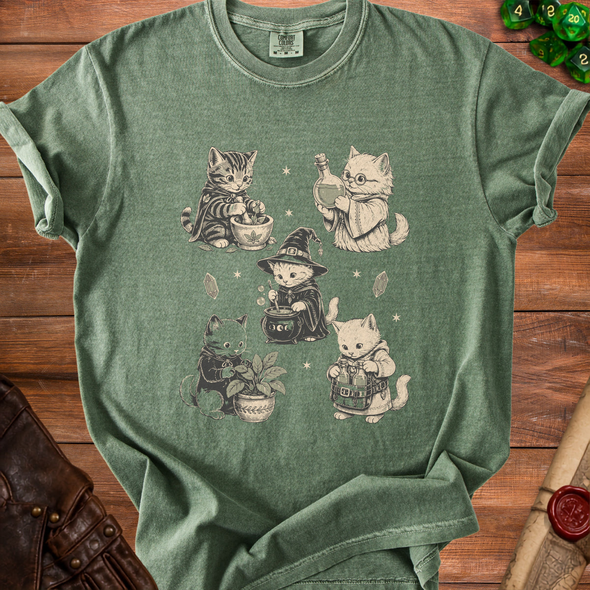 Green t-shirt with vintage illustration of four wizard kittens.