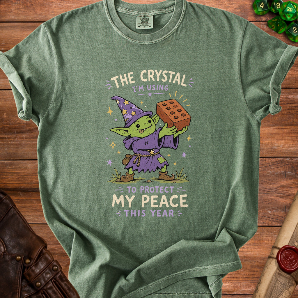 Green t-shirt with goblin graphic and text: "The Crystal I'm Using to Protect My Peace This Year".