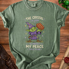 Green t-shirt with goblin graphic and text: "The Crystal I'm Using to Protect My Peace This Year".