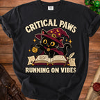 Black t-shirt with a wizard cat graphic reading "Critical Paws Running on Vibes."