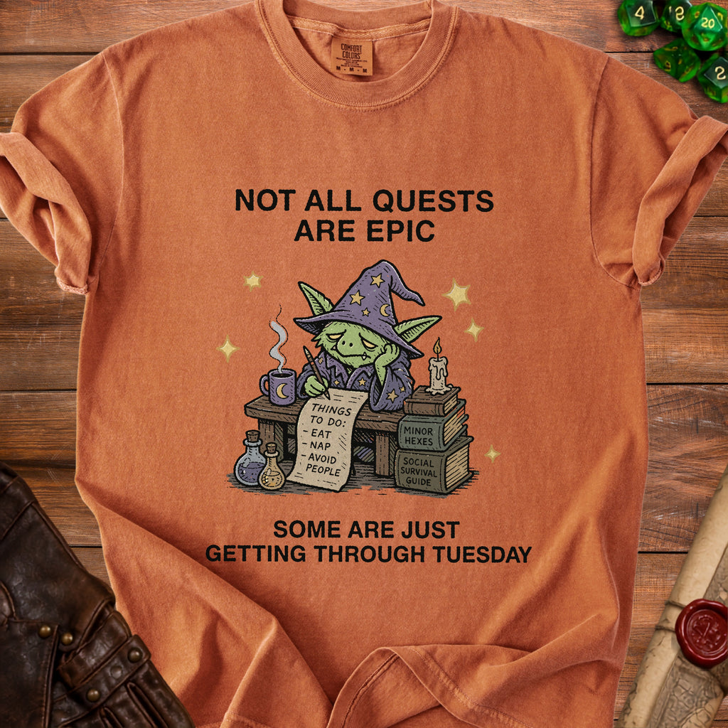 Orange Comfort Colors t-shirt with a goblin character and the text "Not all quests are epic. Some are just getting through Tuesday."