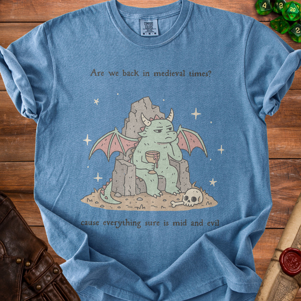 Blue t-shirt with medieval dragon graphic and text "Are we back in medieval times? cause everything sure is mid and evil."