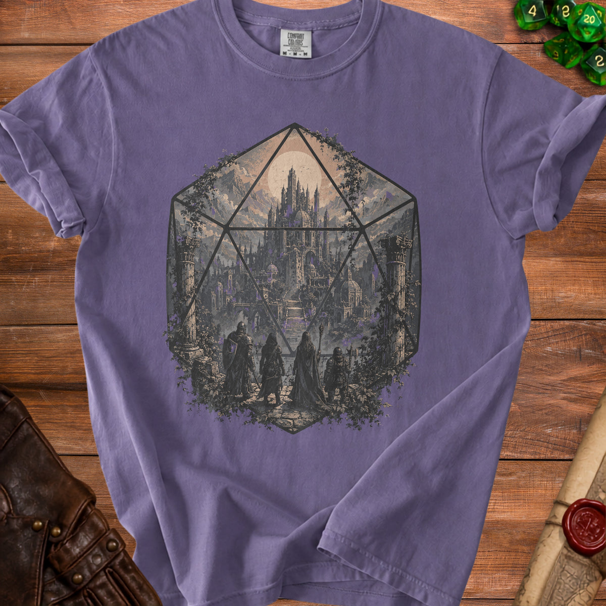 Purple t-shirt with a graphic of a D20 dice containing a fantasy castle and adventurers.