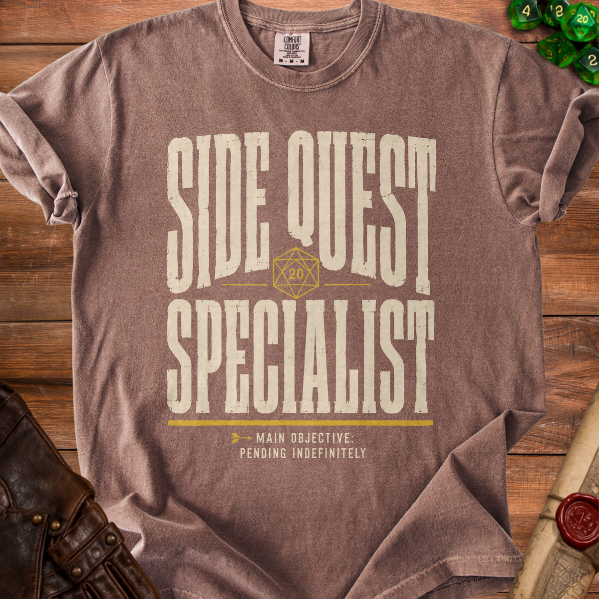 Brown t-shirt with "Side Quest Specialist" and "Main Objective: Pending Indefinitely" text.