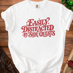White t-shirt with red text saying "Easily Distracted By Side Quests".
