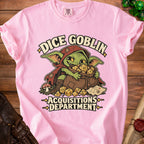 Light pink t-shirt featuring a green goblin graphic hoarding dice and text reading Dice Goblin Acquisitions Department.