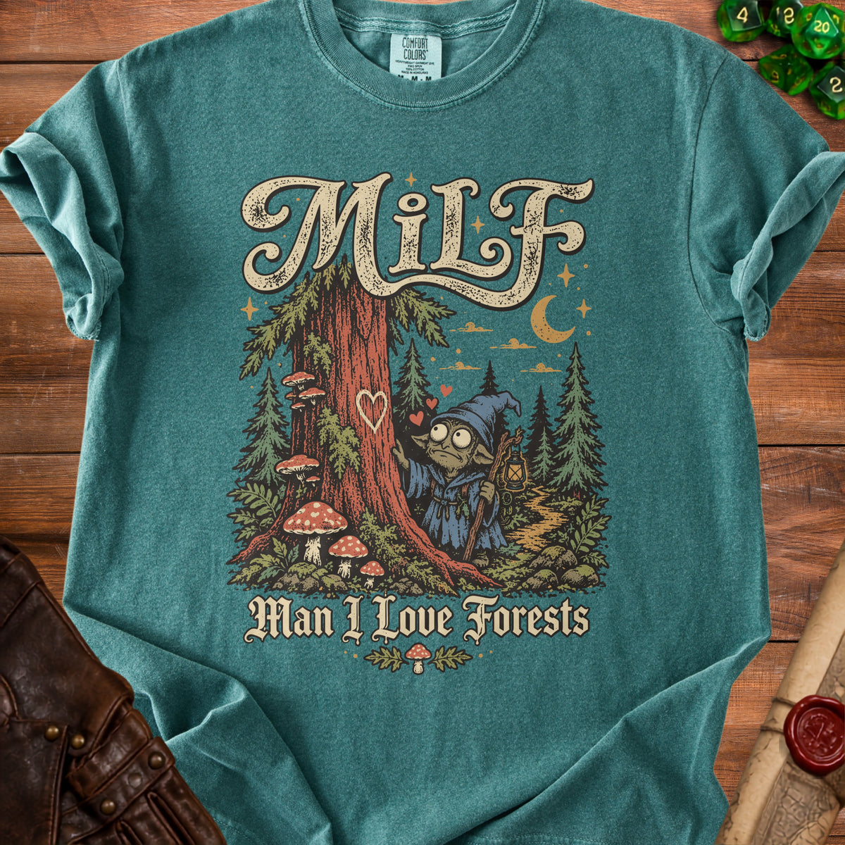 Teal t-shirt with "Milf Man I Love Forests" text and forest gnome graphic.
