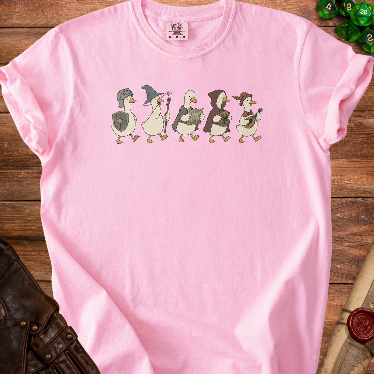 Pink t-shirt with five cartoon ducks dressed as fantasy adventurers.