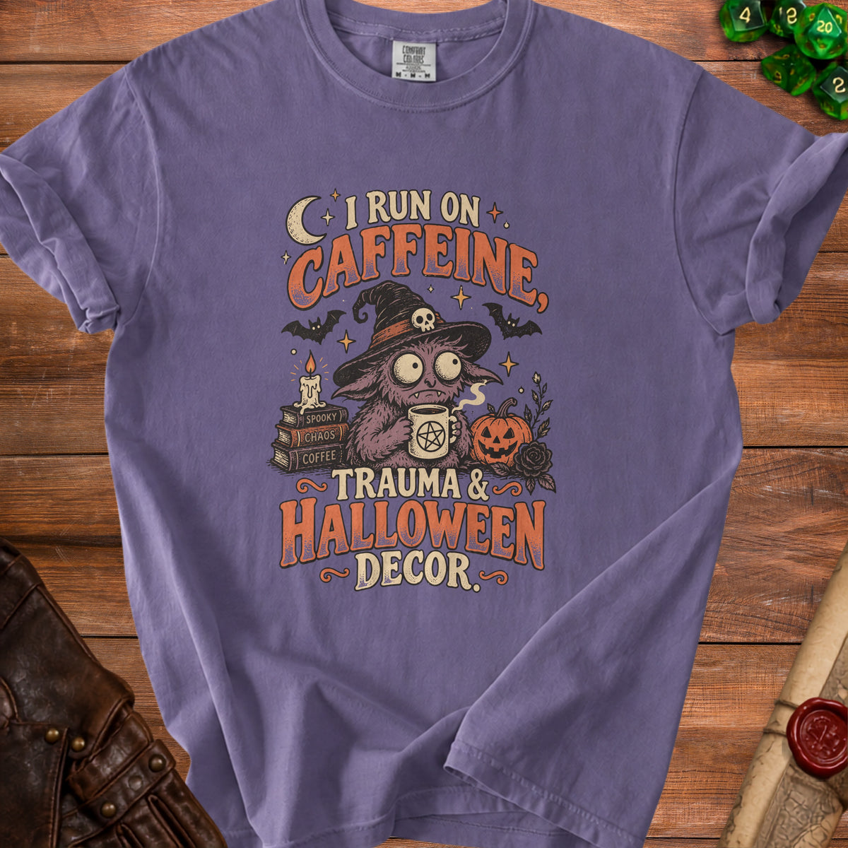 Purple t-shirt with text "I RUN ON CAFFEINE, TRAUMA & HALLOWEEN DECOR."