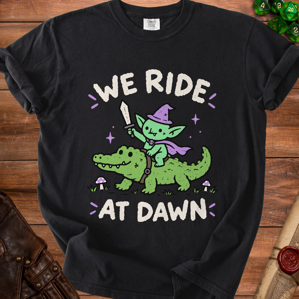 Black t-shirt with "We Ride At Dawn" text and a goblin riding an alligator.