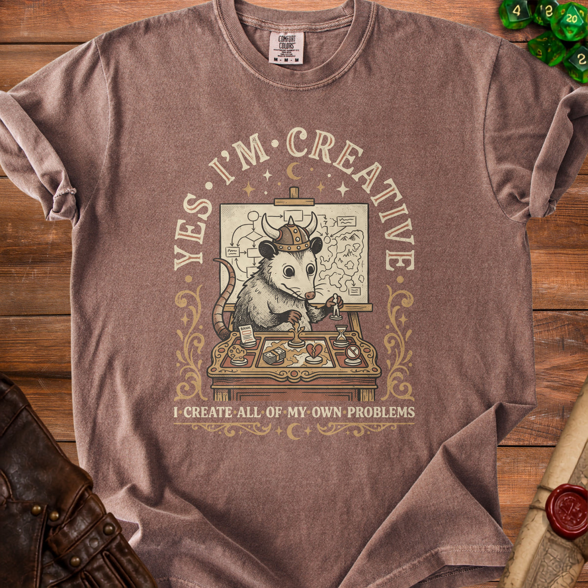 Brown t-shirt with an opossum in a helmet planning on a board with text "Yes, I'm Creative".