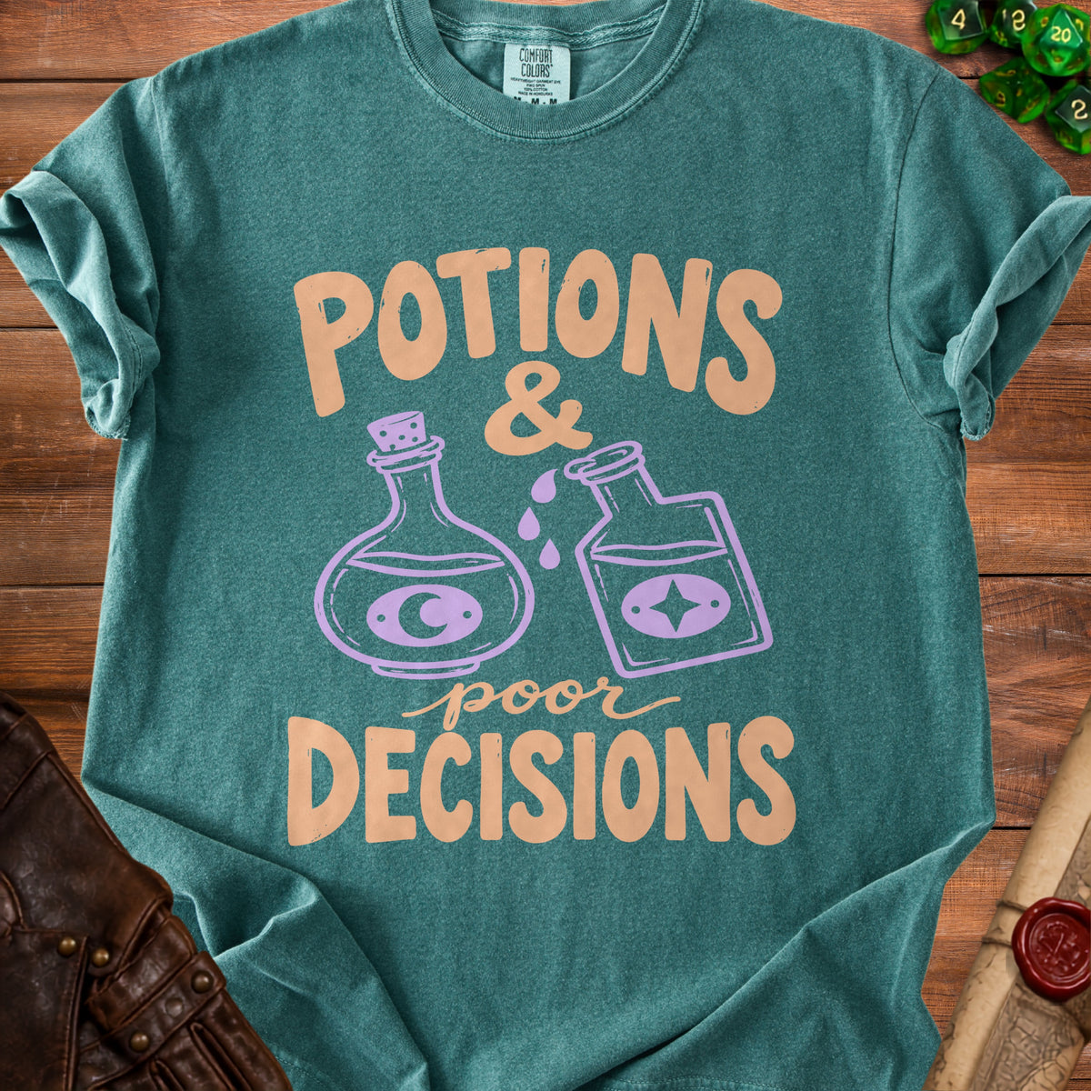 Teal t-shirt with "Potions & Poor Decisions" text and potion bottles graphic.