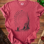 T-shirt with a dark print of a wizard, a spooky tree, and flying bats.