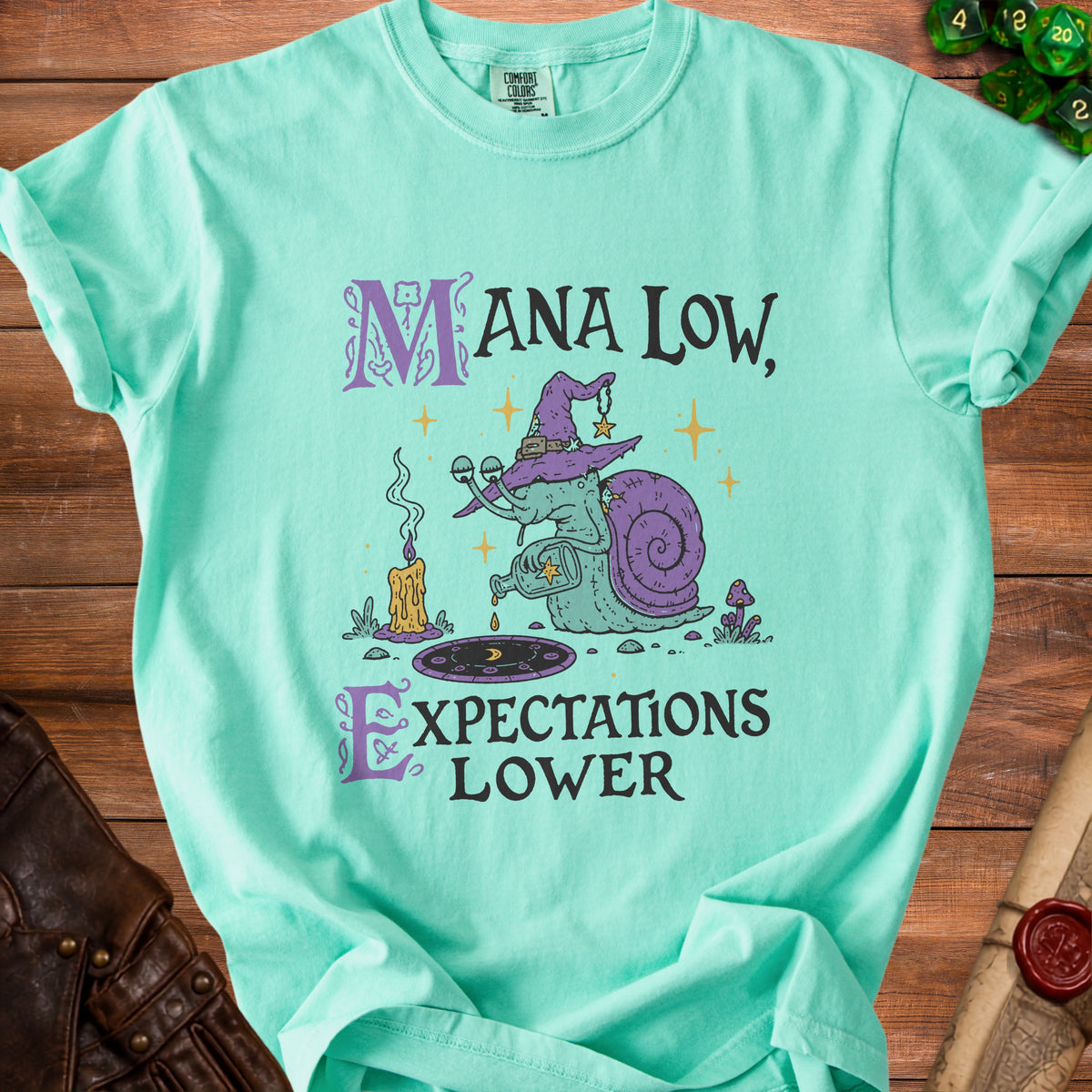 Teal t-shirt with "Mana Low, Expectations Lower" text and a wizard snail graphic.