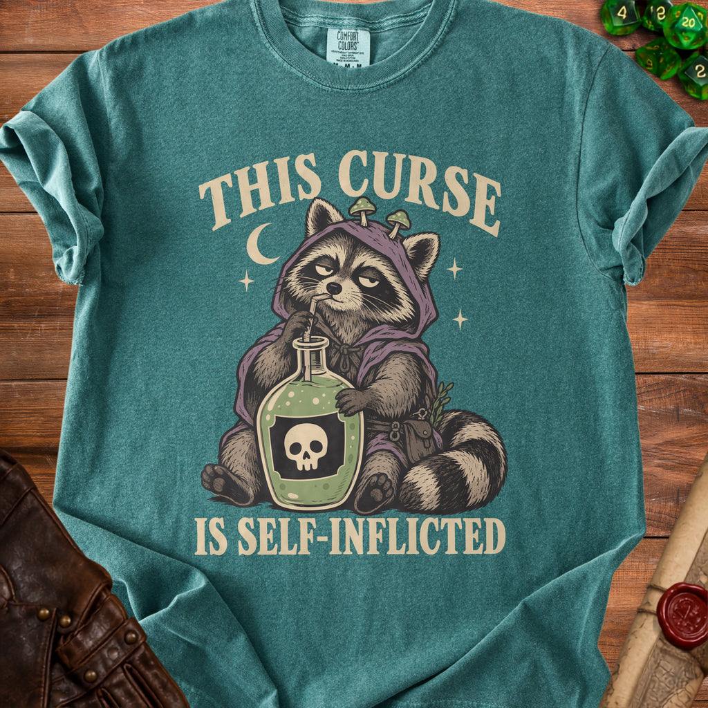 T-shirt graphic of raccoon drinking from bottle with skull, reads "THIS CURSE IS SELF-INFLICTED".