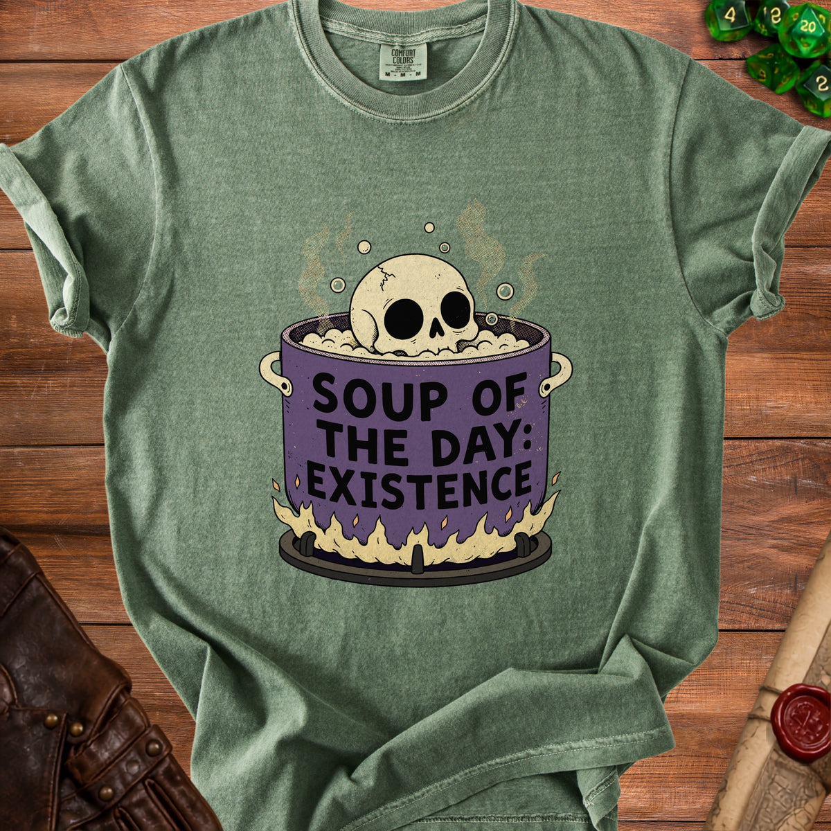 Green t-shirt with skull in soup graphic reading "Soup of the Day: Existence."