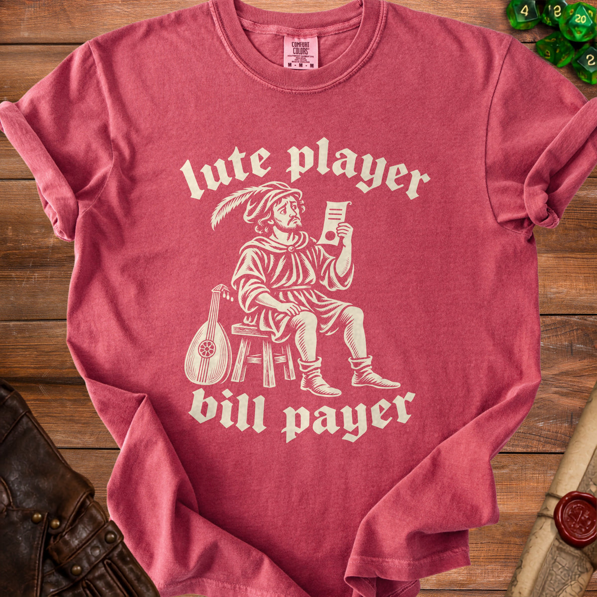 Red t-shirt with beige text and graphic of a lute player holding a document.