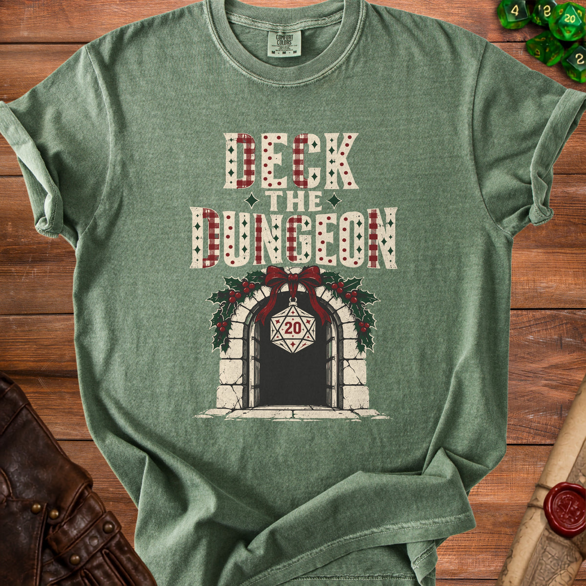Green t-shirt with "Deck the Dungeon" text and a D20 die ornament.