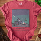 T-shirt with illustration of a wizard by a campfire and text "Not ignoring you. Just recharging my social battery."