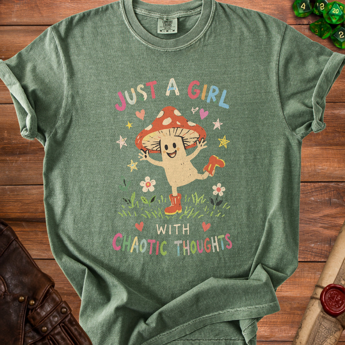 Green t-shirt with "Just a Girl with Chaotic Thoughts" and a mushroom character.