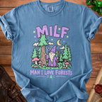 Blue t-shirt with purple text "MILF MAN I LOVE FORESTS" and forest graphic.