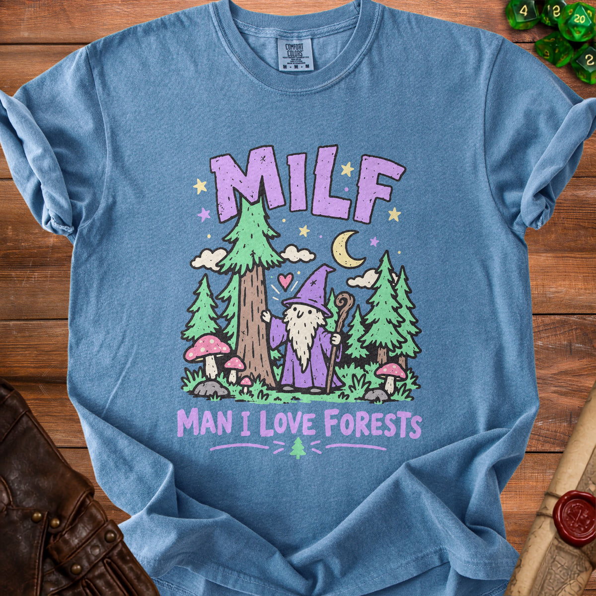 Blue t-shirt with purple text "MILF MAN I LOVE FORESTS" and forest graphic.