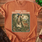 Orange t-shirt with "Terrible Times Excellent Mushrooms" text and forest witch graphic.