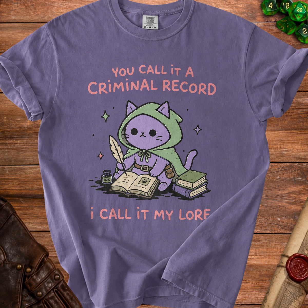 Purple t-shirt with a cartoon cat in a green cloak writing "You call it a criminal record, I call it my lore."