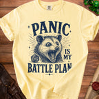 Yellow t-shirt with "Panic is my battle plan" text and possum illustration.