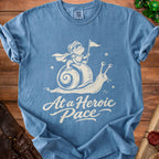 Blue t-shirt with a knight frog riding a snail and text "At a Heroic Pace".