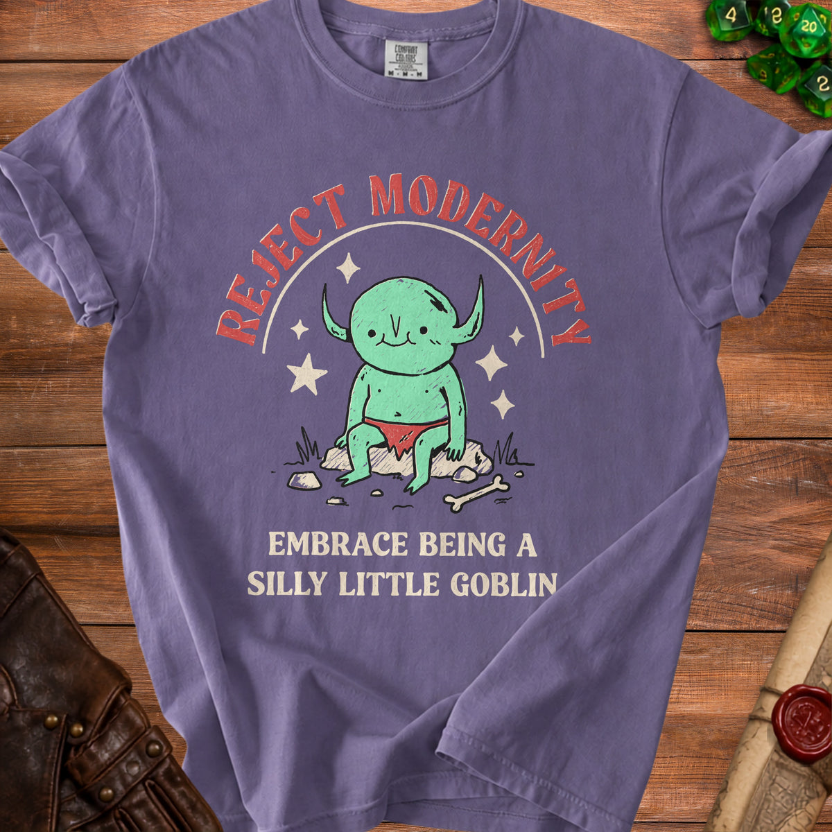 Purple t-shirt with "Reject Modernity Embrace Being a Silly Little Goblin" text.