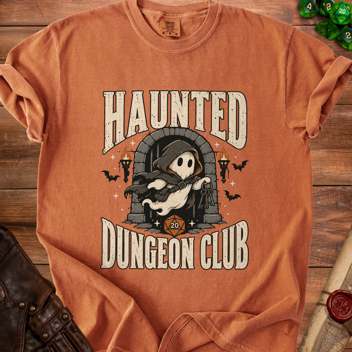 Orange t-shirt with "Haunted Dungeon Club" text and a ghost holding keys.
