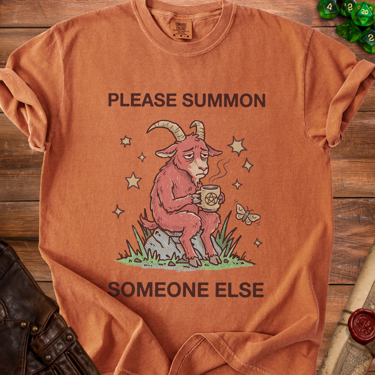Orange t-shirt with a distressed graphic of a tired goat holding a pentagram mug.