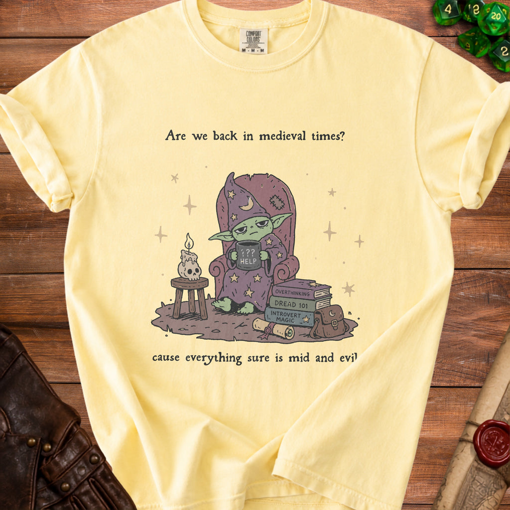 Yellow t-shirt with a goblin wizard and text "Are we back in medieval times? cause everything sure is mid and evil".