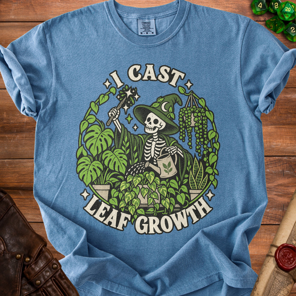 Blue t-shirt with skeleton wizard and plants graphic and "I CAST LEAF GROWTH" text.