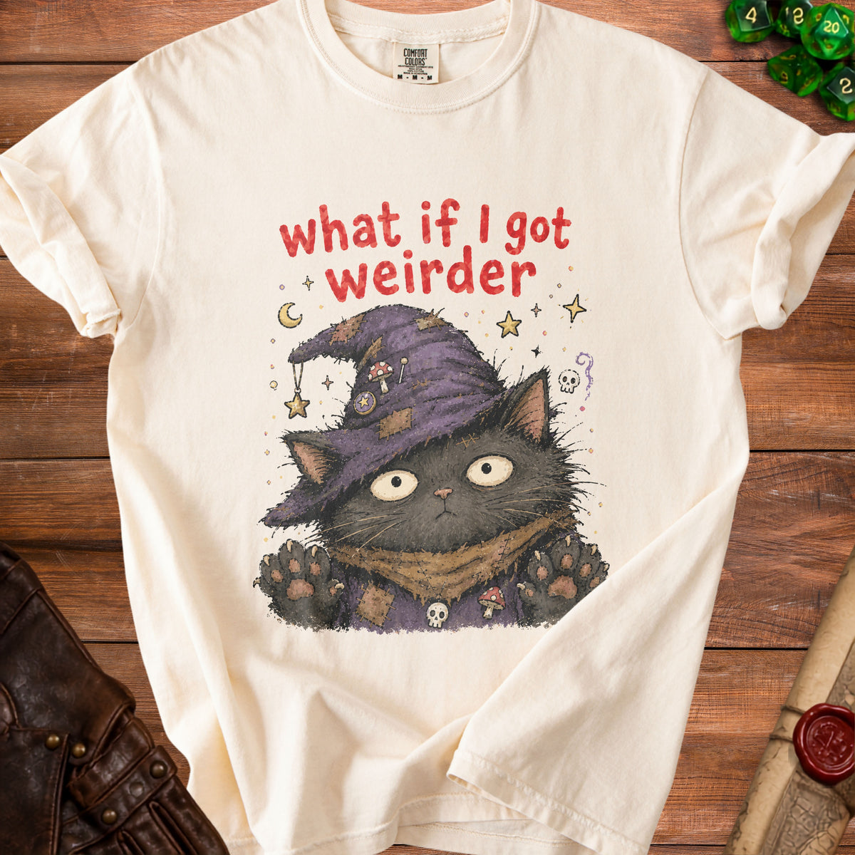 Cream t-shirt with a black cat wearing a witch hat and the text "what if I got weirder".