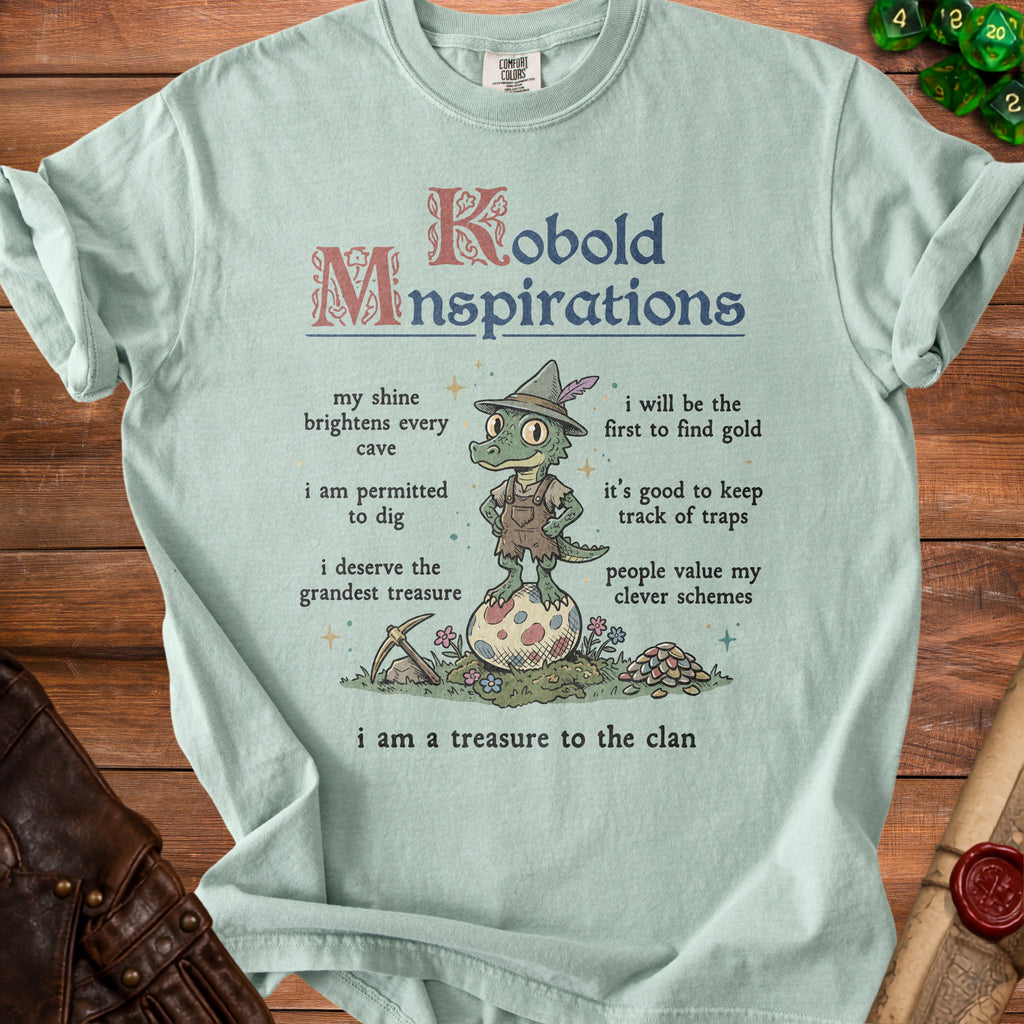 Light blue t-shirt with "Kobold Mnspirations" text and a cartoon lizard.