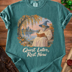 Teal t-shirt with wizard reading by lake graphic and "Quest Later, Rest Now" text.