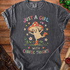 T-shirt with graphic of a smiling mushroom and text "Just a girl with chaotic thoughts."