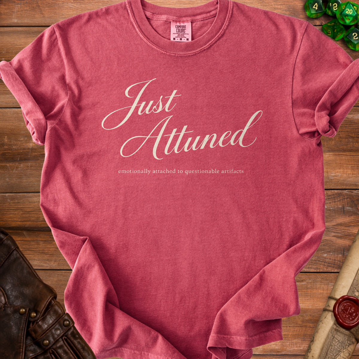 Crimson t-shirt with "Just Attuned" and "emotionally attached to questionable artifacts".