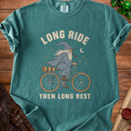 Teal t-shirt with wizard on bicycle, text "LONG RIDE THEN LONG REST".