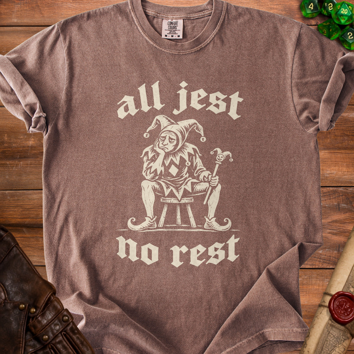Brown t-shirt with "all jest no rest" text and a sad jester illustration.