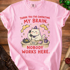Pink t-shirt with a cat at a desk saying "Thank you for contacting my brain. Nobody works here."