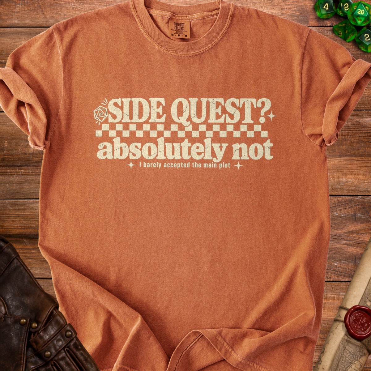Orange t-shirt with "SIDE QUEST? absolutely not" text and gaming dice.