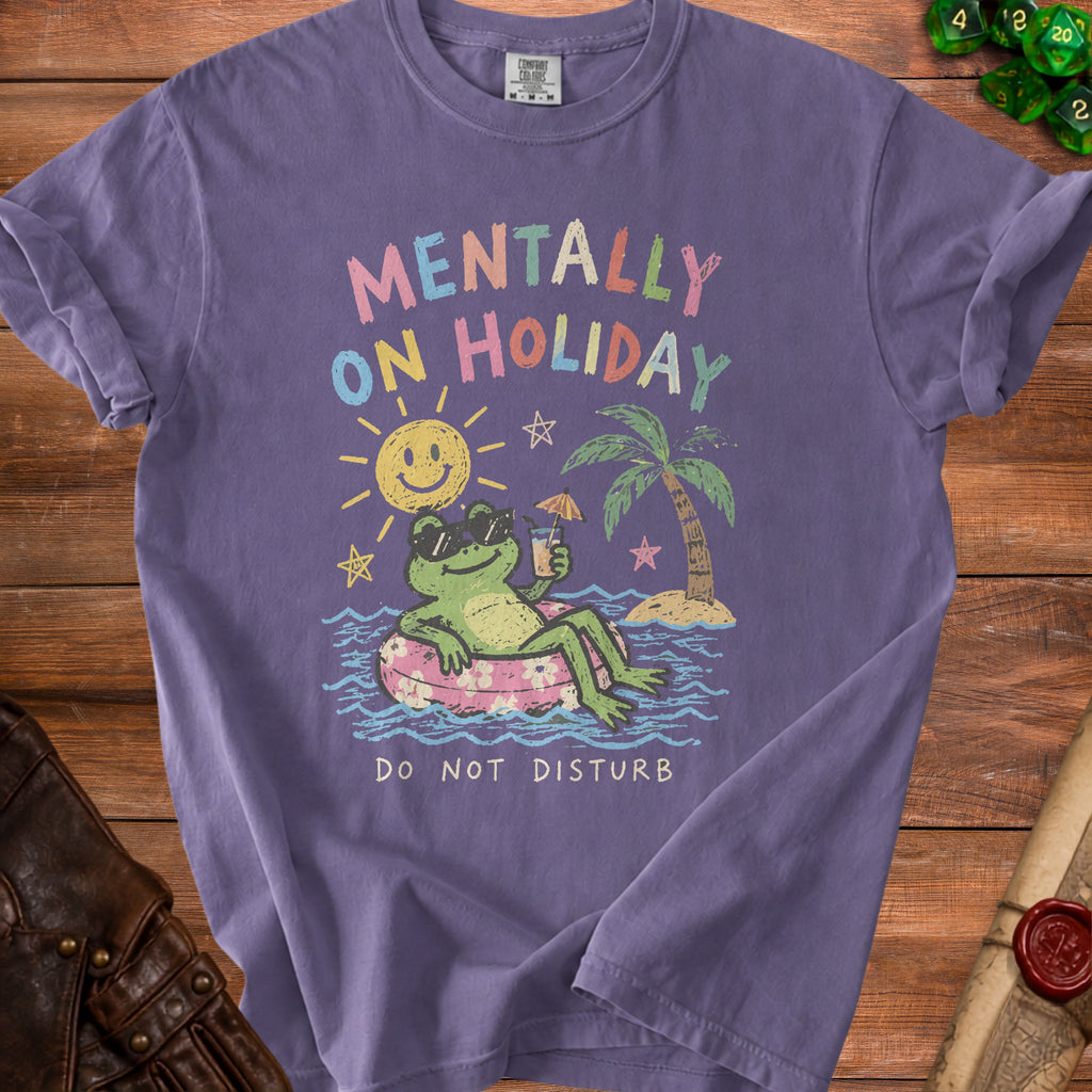Purple t-shirt with a graphic of a frog on an inner tube saying "Mentally On Holiday".